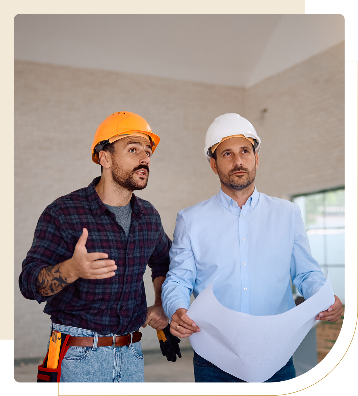 Two construction workers discussing building plans.